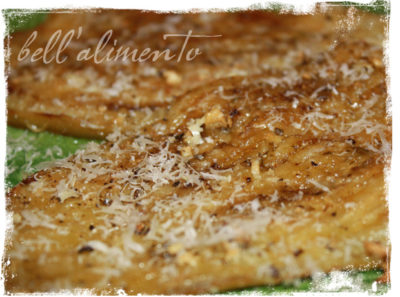 slices of baked eggplant with grated cheese