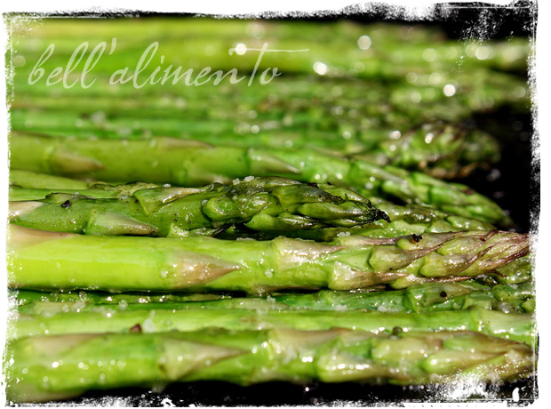 close up image of many asparagus spears on grill