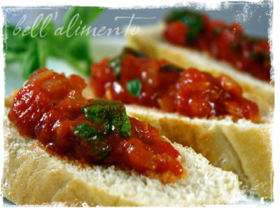3 crostini topped with pepperonata garnished with herbs. 