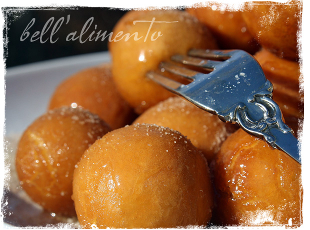 struffoli balls on white plate with fork