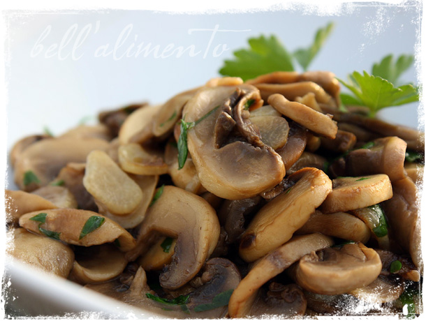 Sauteed mushrooms with parsley on white plate. 