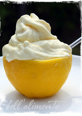 lemon gelato in a lemon with spoon.