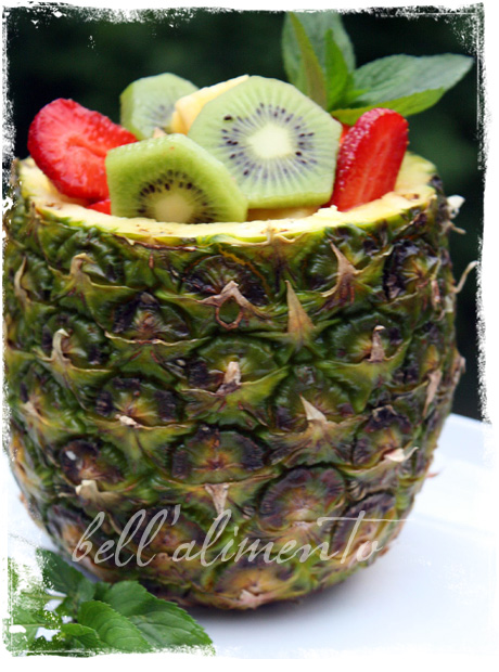 Pineapple filled with fresh fruit.