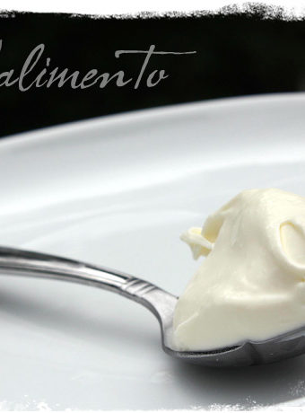 spoon with mascarpone on white plate.