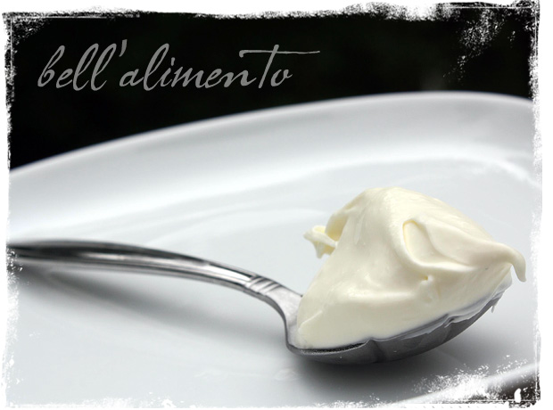 spoon with mascarpone on white plate.