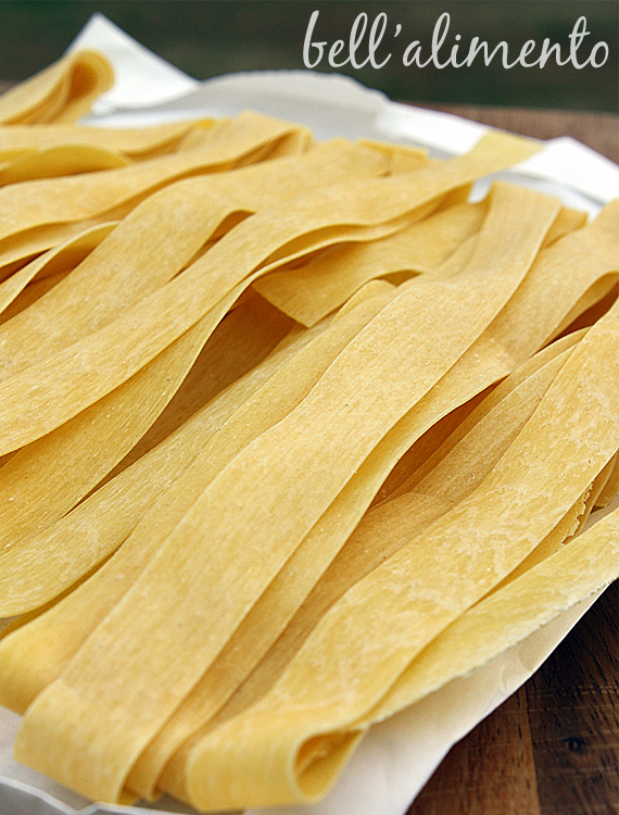 ribbons of pappardelle pasta on tray. 