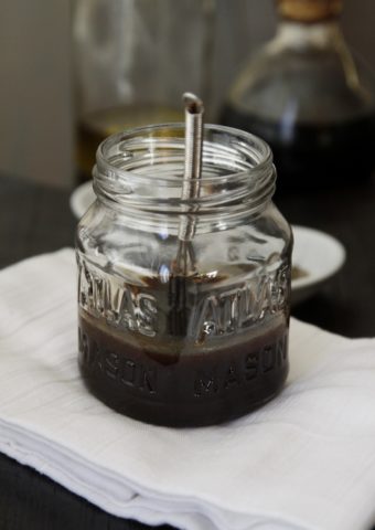 balsamic vinaigrette in small glass jar with metal whisk.