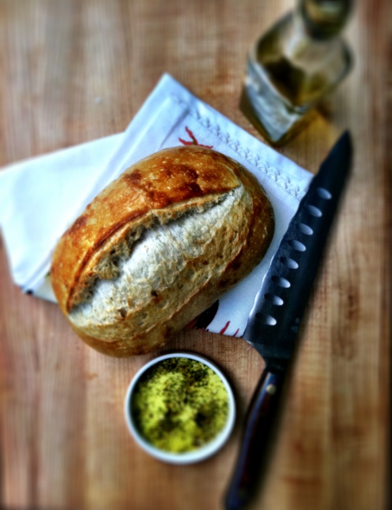 homemade bread with bread knife and dipping sauce