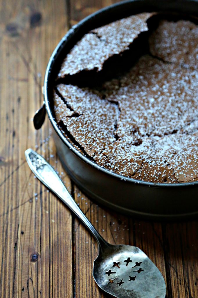 chocolate cake in pan. Serving piece to side.