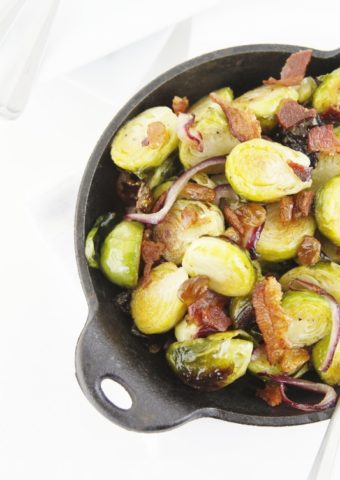 roasted brussels sprouts with bacon in cast iron pan.
