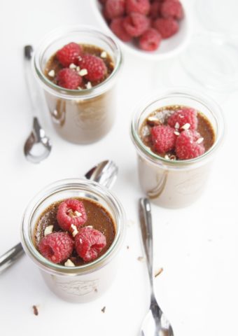 nutella pots de creme topped with raspberries served in individual jars with small spoons