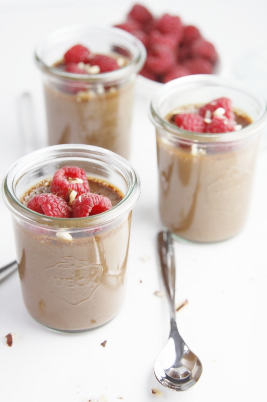 nutella hazelnut pots de creme topped with raspberries served in individual jars with small spoons 