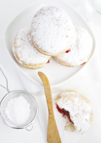 Strawberry Jelly Filled Doughnuts on white plate.
