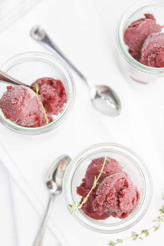 3 small glass jars of Blueberry Thyme Sorbet. 2 small spoons visible to side. 