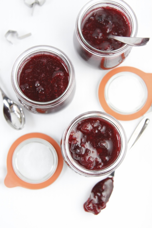 Three small glass jars of small batch berry jam.