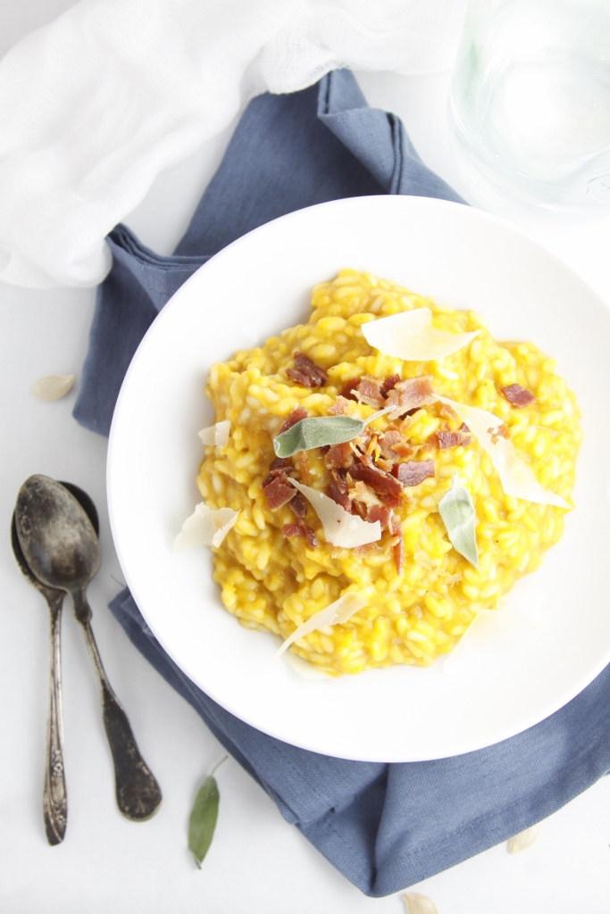 bowl of Roasted Pumpkin Risotto with Pancetta on blue napkin with spoons