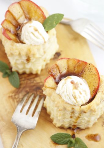 Apple Pie Puff Pastry Cups on cutting board with fork.