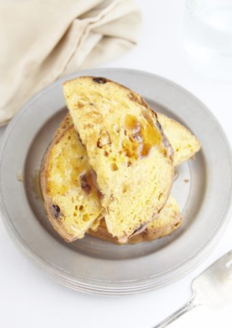panettone french toast with maple syrup on pewter plate.