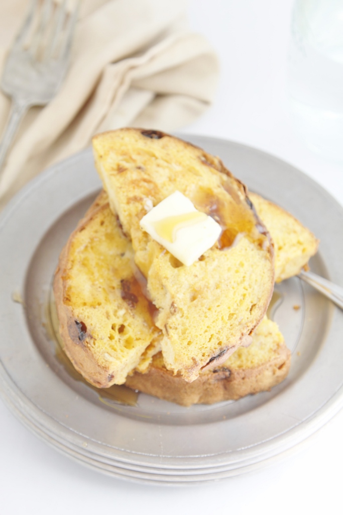 Panettone French Toast with syrup and butter on pewter plate. 