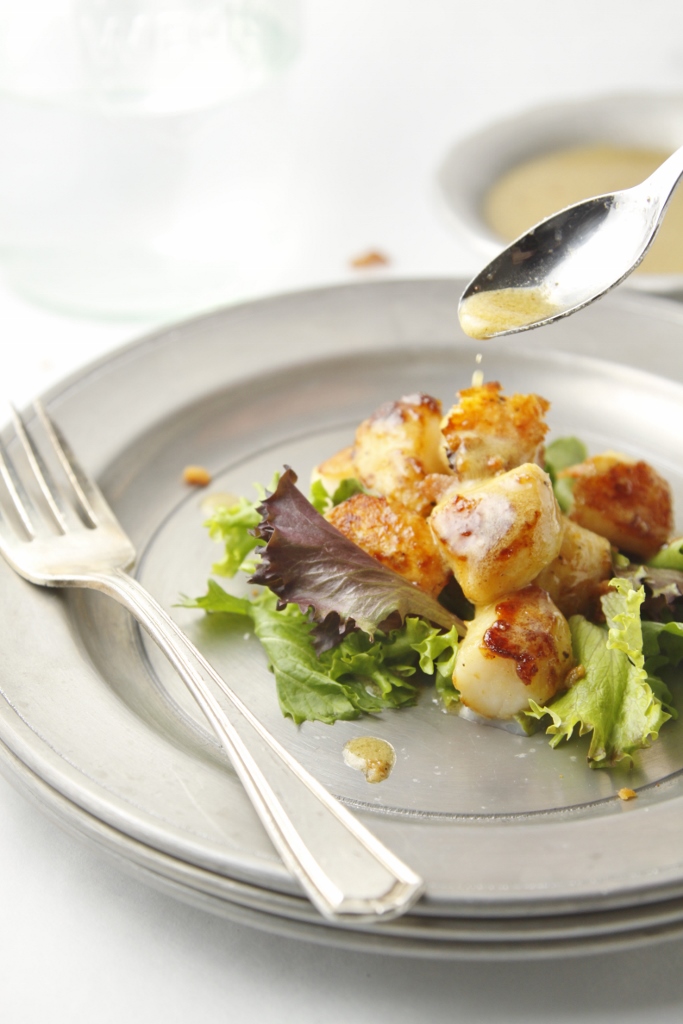 Seared Scallops with Creamy Bacon Vinaigrette on silver plate with fork. 
