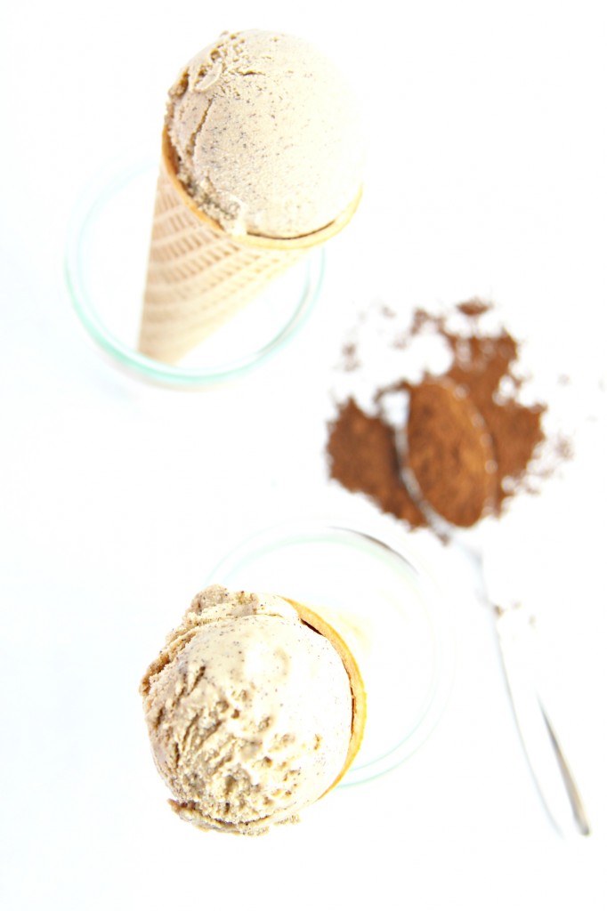 Espresso Ice Cream Cone standing in small glass jar. Spoon with espresso grounds to right. Top of cone visible in front. 