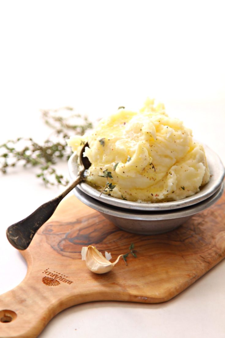 mashed potatoes in small metal bowl with spoon.