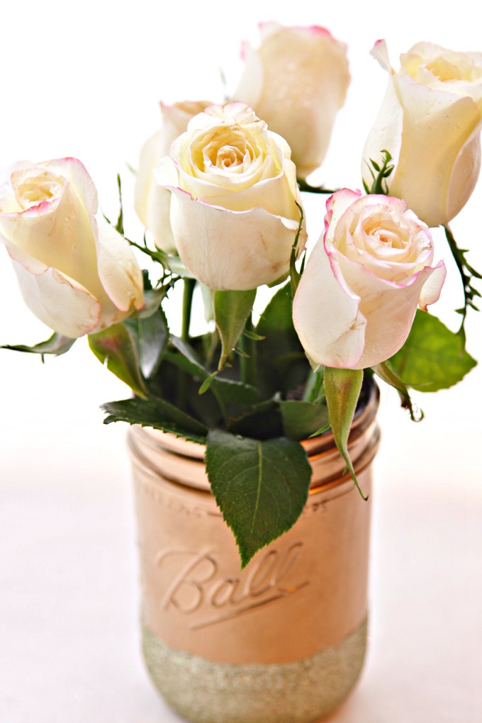 gold painted mason jar with white roses. 
