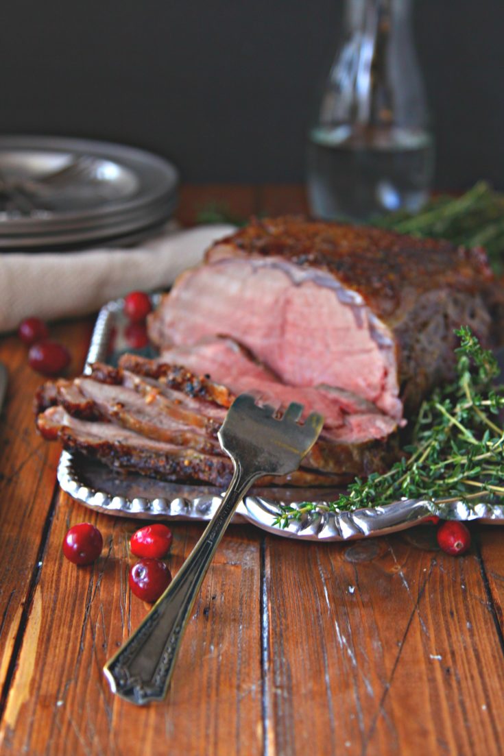 The Perfect Holiday Beef Roast on silver platter with fork