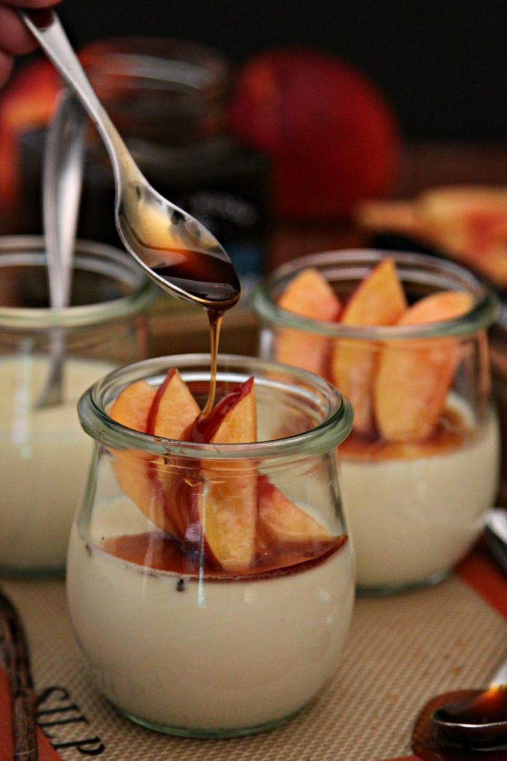 Vanilla Bean Panna Cotta with Nectarines and Honey in jars with spoon drizzled honey on top
