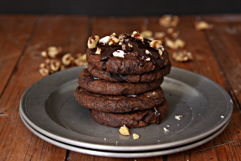 Stack of Rocky Road Cookies on metal plate. Nuts scattered in background. 
