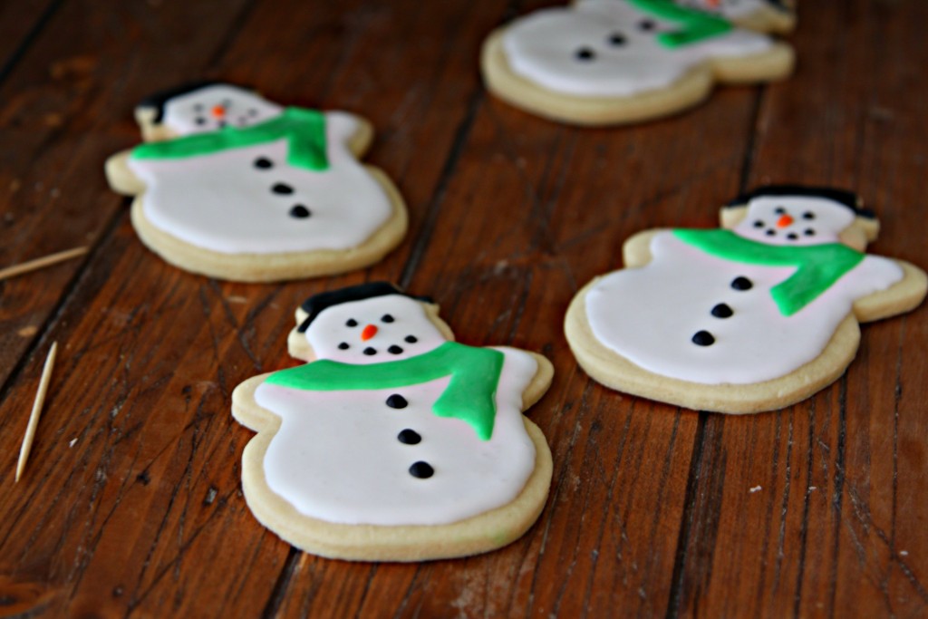 Four Snowman Sugar Cookies. Toothpicks to side. 