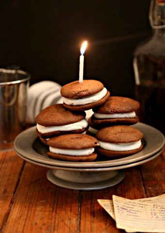 whoopies pies on a plate topped with a birthday candle