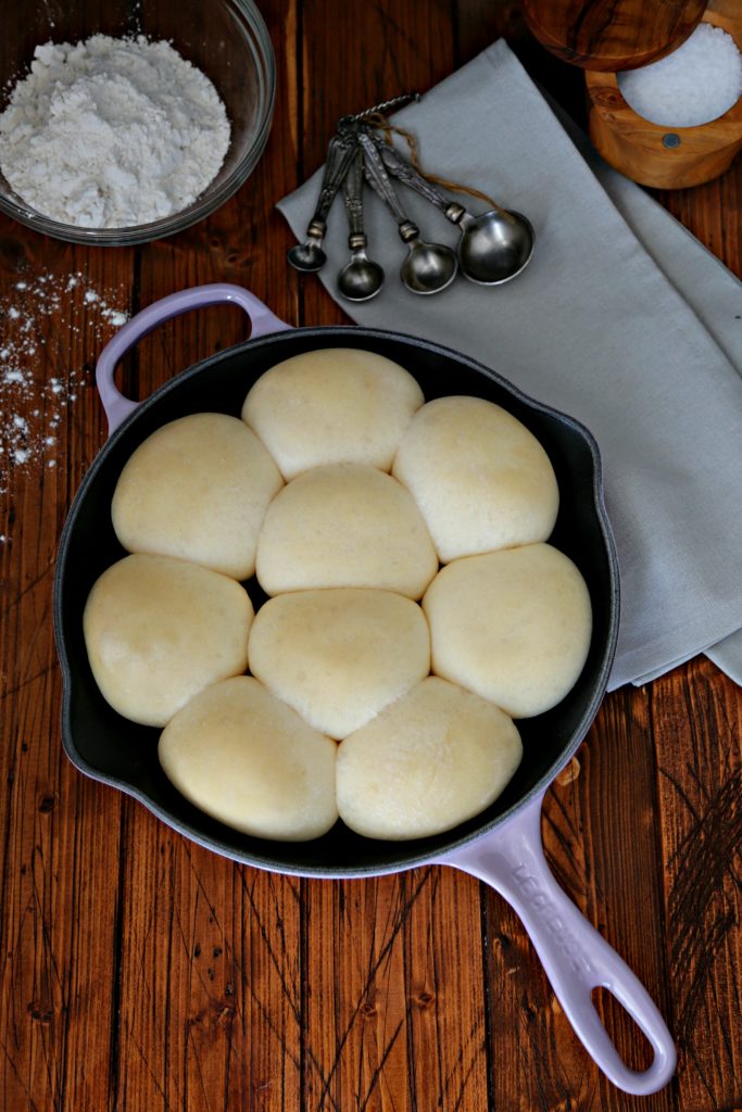dinner rolls in lavender skillet ready to be baked