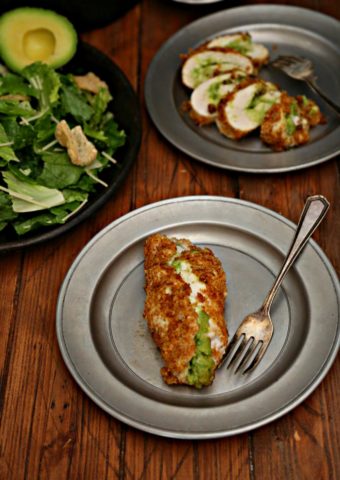 Keto Avocado Stuffed Chicken on silver plate with side of salad