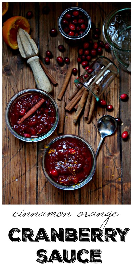 Cinnamon Orange Cranberry Sauce in jars with cinnamon sticks and fresh cranberries surrounding