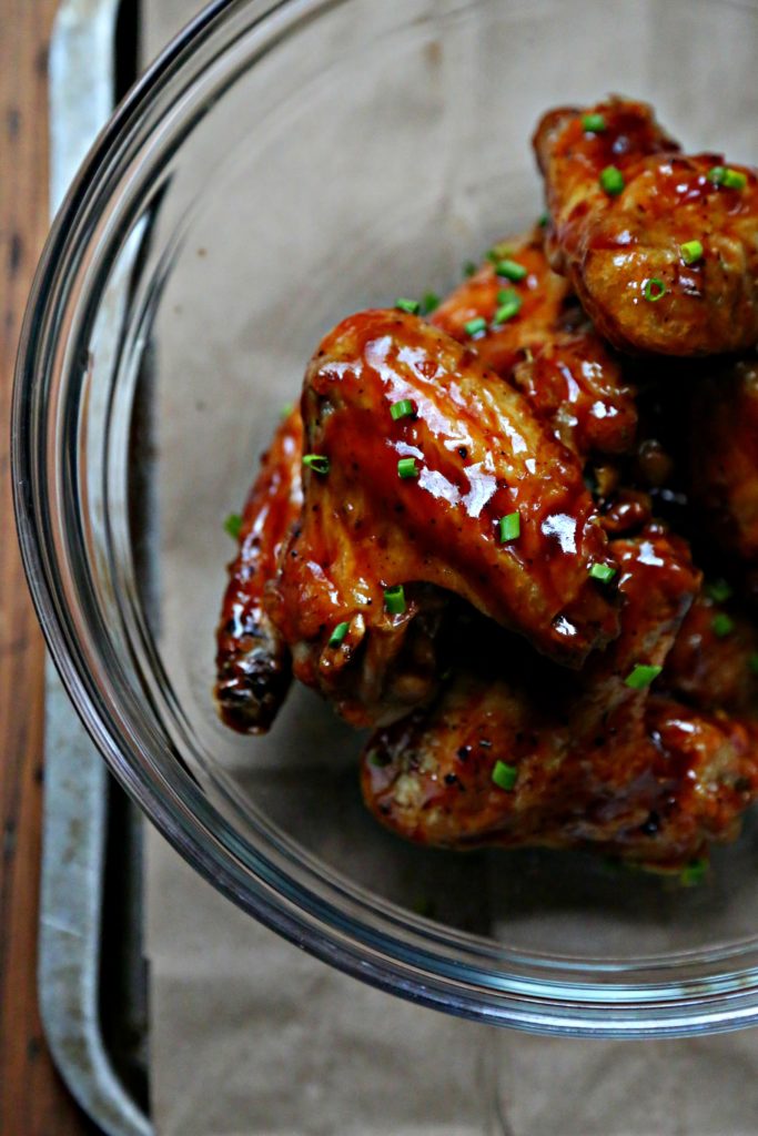 Chicken wings with bbq sauce in glass bowl. 