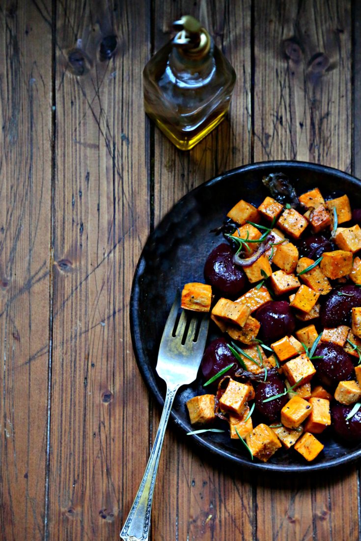 Roasted Sweet Potatoes and Beets on brown plate with fork.