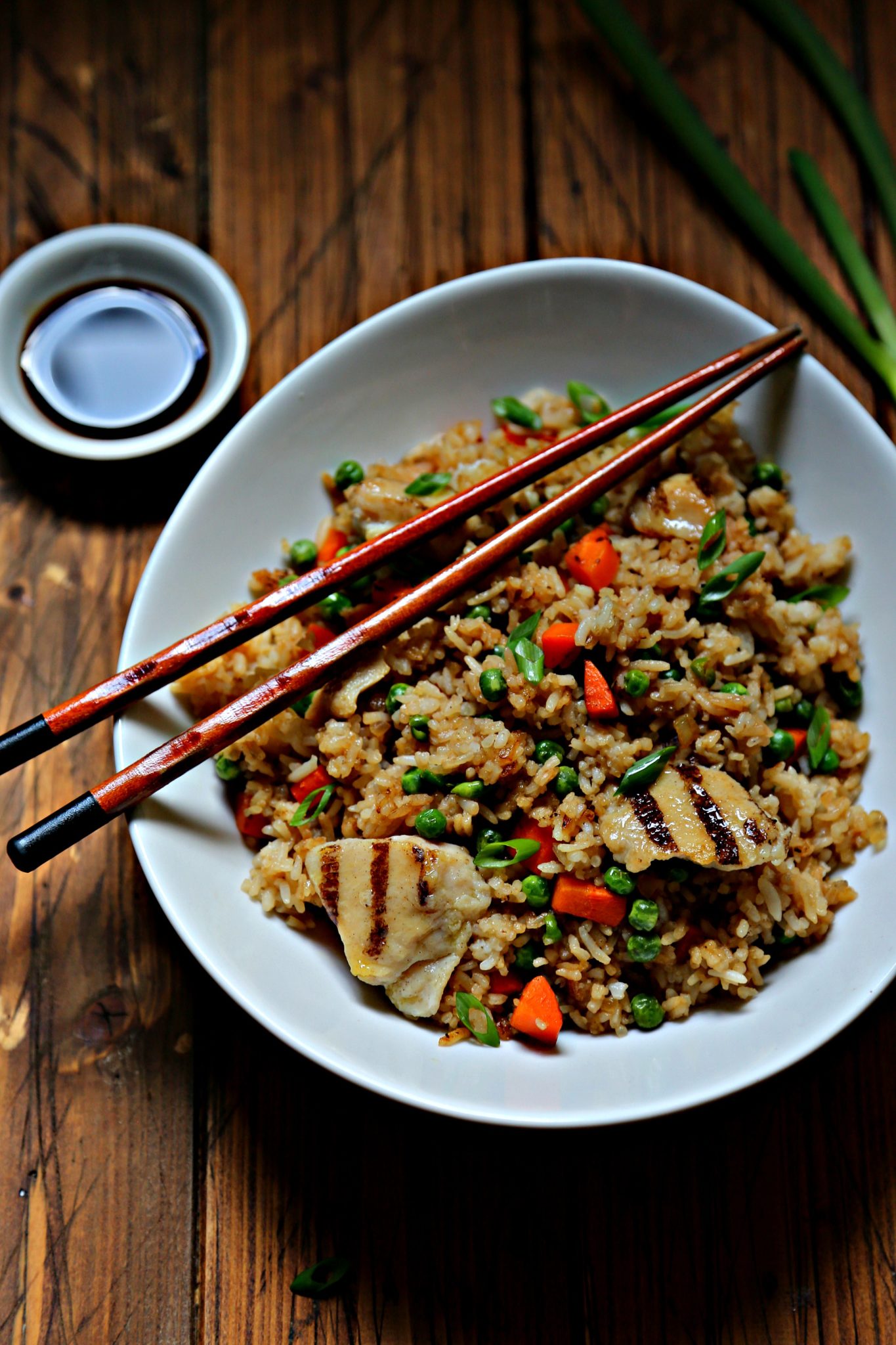 chicken fried rice in white bowl with chopsticks.