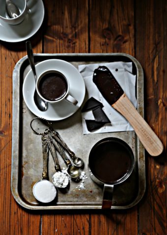 Italian hot chocolate on silver tray with spoon and ingredients via bell'alimento