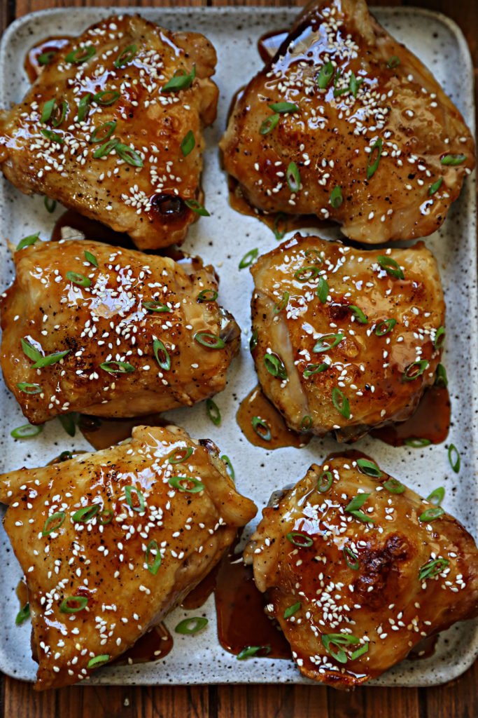 six glazed chicken thighs on platter