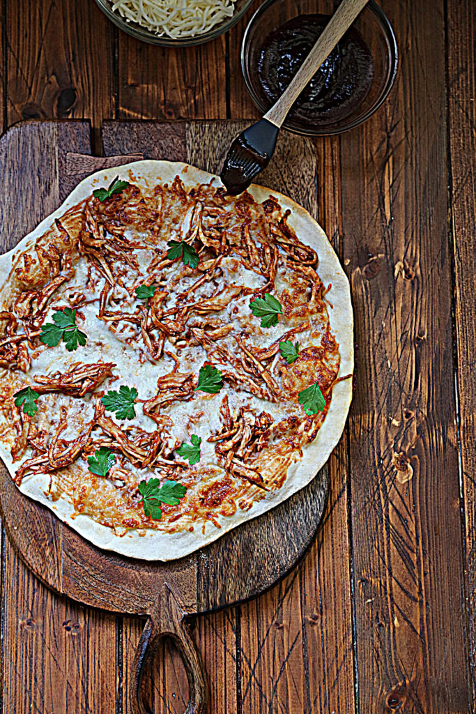 bbq turkey pizza on cutting board. 